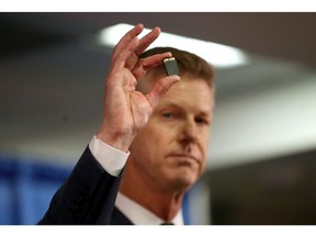 United States attorney David L. Anderson holds an SD memory card as he speaks during a news conference on September 30, 2019 in San Francisco, California. The U.S. attorney's office of the Northern District of California announced a criminal complaint against Xuehua Peng, also known as Edward Peng, for acting as an illegal foreign agent that allegedly delivered classified U.S. national security information to the government of the People's Republic of China's Ministry of State Security.