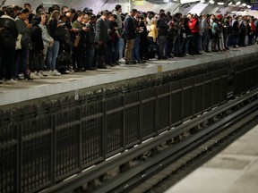 Commuters wait to board a metro at the Gare du Nord subway station during a strike by all unions of the Paris transport network (RATP) against pension reform plans in Paris, Sept. 13, 2019.  REUTERS/Christian Hartmann