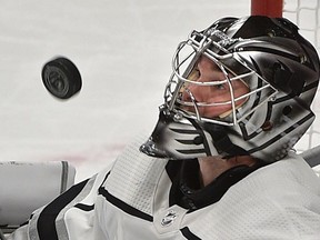Los Angeles Kings goalie Jack Campbell keep his eyes on the airborne puck playing against the Edmonton Oilers during NHL action at Rogers Place in Edmonton, March 26, 2019.