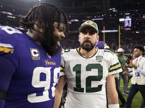 Vikings' Linval Joseph, left, and Aaron Rodgers of the Packers greet each other on the field after the game at U.S. Bank Stadium in Minneapolis, Minn., on Nov. 25, 2018.