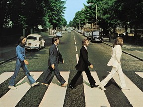 Members of the Beatles (from left to right), George Harrison, Paul McCartney, Ringo Starr, John Lennon, cross Abbey Road in London, Aug. 8, 1969. (Iain Macmillan, courtesy Apple Corps/via REUTERS)