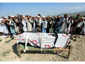 Relatives and residents pray near a coffin during a funeral ceremony of one of the victims after a drone strike, in Khogyani district of Nangarhar province, Afghanistan September 19, 2019.