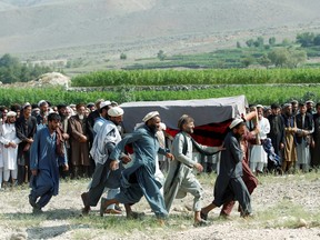 Men carry a coffin of one of the victims after a drone strike, in Khogyani district of Nangarhar province, Afghanistan September 19, 2019.