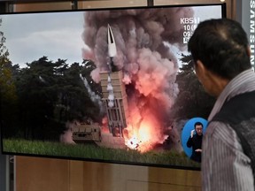 A man watches a television news screen showing file footage of a North Korean missile launch, at a railway station in Seoul on September 10, 2019. - North Korea on September 10 fired projectiles toward the sea, South Korea's military said, hours after Pyongyang said it is willing to hold working-level talks with the United States in late September.