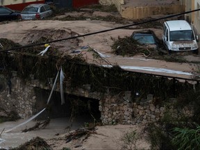Damaged cars are pictured after a street was flooded in Ontinyent on Sept. 12, 2019 as torrential rains hit southeastern Spain overnight, sparking major flooding in the Valencia region and closing schools in a move affecting a quarter of a million children. (JOSE JORDAN/AFP/Getty Images)