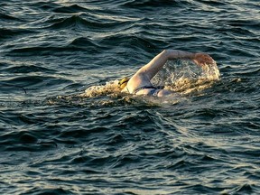 A handout photograph taken off the coast of Dover, southern England on September 15, 2019, and released by Jon Washer Photoraphy on September 17, 2019 shows US swimmer Sarah Thomas swimming in the Dover Strait, 10 miles off the English coast, on the first leg of her non-stop four leg, 54 hour, cross-Channel swim between England and France. - An American breast cancer survivor on September 17, became the first person to swim across the Channel four times non-stop in a 54-hour feat of endurance. Sarah Thomas, 37, an open water marathon swimmer from the US state of Colorado, could be seen in a video posted on Facebook arriving at Dover on the southern English coast with a group of supporters cheering her on.