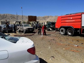 An Afghan firefighter sprays water on the ground at the site of a suicide attack that targeted a campaign rally for Afghan President Ashraf Ghani in Parwan Province on the outskirts of Kabul on September 17, 2019. - A suicide bomber killed at least 24 people outside a campaign rally for Afghan President Ashraf Ghani on September 17, less than two weeks ahead of elections which the Taliban have vowed to disrupt.