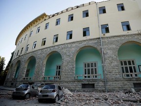 Destroyed cars stand next to a damaged building after an earthquake in Tirana, Albania, September 21, 2019.