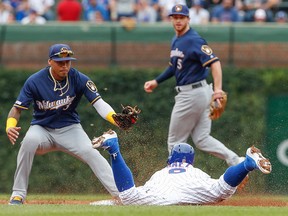 Chicago Cubs shortstop Javier Baez steals second base against Milwaukee Brewers shortstop Orlando Arcia during the third inning at Wrigley Field.