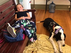 Bella Burton and her service dog George are pictured in a photo posted on the Bella and George Facebook page. (Bella and George/Facebook) George/Facebook)