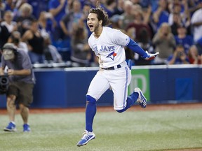 Bo Bichette of the Toronto Blue Jays leaps as he runs into home plate, after hitting a home run to score the winning run in the 12th inning of their game against the New York Yankees at Rogers Centre on Sept. 13, 2019 in Toronto.