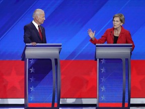 Former Vice President Joe Biden look on as Sen. Elizabeth Warren (D-MA) speaks during the Democratic Presidential Debate at Texas Southern University's Health and PE Center in Houston, on Thursday, Sept. 12, 2019.