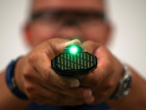 Trainer Michael Harding points a laser-guided new non-lethal weapon by BolaWrap during training in Laguna Niguel, California, September 5, 2019. (REUTERS/Mike Blake)