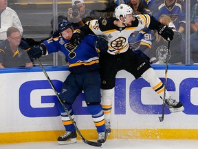 Boston Bruins defenceman Brandon Carlo (25) checks St. Louis Blues right winger Vladimir Tarasenko into the boards during Game 3 of the Stanley Cup Final at Enterprise Center. (Billy Hurst-USA TODAY Sports)