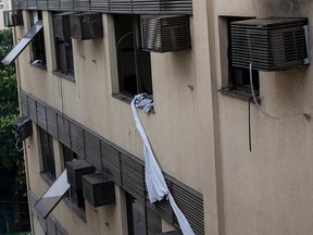 Sheets tied together hang from a window of the Badim Hospital following a fire in Rio de Janeiro, on September 13, 2019. (MAURO PIMENTEL/AFP/Getty Images)