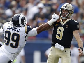 Drew Brees of the New Orleans Saints injures his throwing hand as he is hit by Aaron Donald of the Los Angeles Rams at Los Angeles Memorial Coliseum on September 15, 2019 in Los Angeles. (Sean M. Haffey/Getty Images)