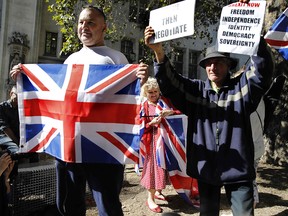 Pro-Brexit demonstrators wave the Union flag and hold placards outside the Supreme Court in central London, on September 18, 2019. (TOLGA AKMEN/AFP/Getty Images)
