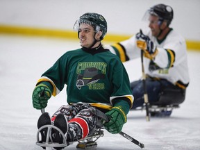 Humboldt Broncos bus crash survivor Ryan Straschnitzki, left, plays in a fund raising sledge hockey game in Calgary on September 15, 2018. An ad shows a serious Ryan Straschnitzki taping up his hockey stick and pulling on an Adidas jersey before he slides away on an ice sled. "As a kid I always dreamed of playing for Team Canada ... and I still do," Straschnitzki narrates in the commercial. Sixteen people were killed and 13, including Straschnitzki, were injured in the collision in rural Saskatchewan. Shortly after the crash, Straschnitzki made it his goal to join Canada's sledge hockey team and win a gold medal at the Paralympic Games.