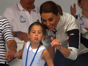 Britain's Princess Charlotte sticks her tongue out next to her mother, Catherine Duchess of Cambridge, before a presentation ceremony following the King's Cup Regatta in Isle of Wight, Britain August 8, 2019. (REUTERS/Peter Nicholls)
