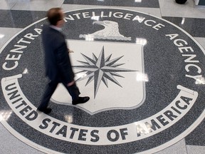 In this file photo taken on August 13, 2008 a man walks over the seal of the Central Intelligence Agency in the lobby of CIA Headquarters in Langley, Virginia, on August 14, 2008. (SAUL LOEB/AFP/Getty Images)