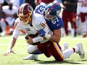 Washington Redskins quarterback Case Keenum  is sacked by inside linebacker Ryan Connelly of the New York Giants during the first quarter of the game at MetLife Stadium on Sept. 29, 2019 in East Rutherford, N.J.