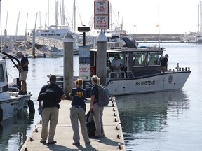 FBI personnel gather on a jetty as an FBI Dive Team boat departs in Santa Barbara Harbor on September 4, 2019 in Santa Barbara, California. (Mario Tama/Getty Images)
