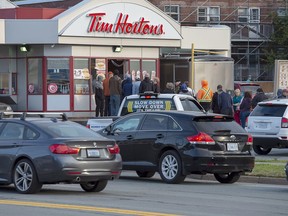 Customers line up at a Tim Hortons on Sunday, Sept. 8, 2019. The City of Fredericton will spend $40,000 to direct motorists around a busy Tim Hortons, in the latest move by a Canadian municipality to curb traffic headaches and other concerns caused by restaurant drive-thrus.
