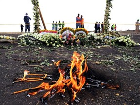 Candle flames burn during a commemoration ceremony for the victims at the scene of the Ethiopian Airlines Flight ET 302 plane crash, near the town Bishoftu, near Addis Ababa, Ethiopia March 14, 2019.