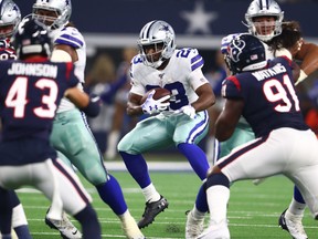 Dallas Cowboys running back Alfred Morris runs with the ball in the second quarter against the Houston Texans at AT&T Stadium.