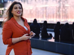 Saudi human resources professional Mashael al-Jaloud, 33, walks in western clothes past Saudis wearing traditional Islamic garment, at a commercial area in the Saudi capital Riyadh on Sept. 3, 2019. (FAYEZ NURELDINE/AFP/Getty Images)