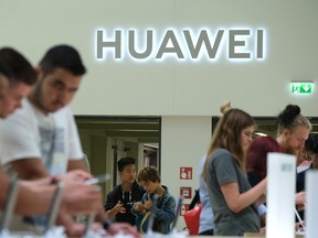 Visitors check out new Huawei smartphones at the 2019 IFA home electronics and appliances trade fair on September 06, 2019 in Berlin, Germany. The 2019 IFA fair will be open to the public from September 6-11.