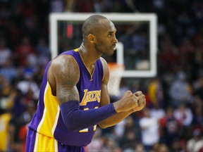 Kobe Bryant #24 of the Los Angeles Lakers celebrates a play during their game against the Houston Rockets at the Toyota Center on November 19, 2014 in Houston, Texas.