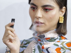A model smokes a vape before the Snow Xue Gao Spring Summer 2018 show during New York Fashion Week on Sept. 8, 2017 in New York. (EDUARDO MUNOZ ALVAREZ/AFP/Getty Images)