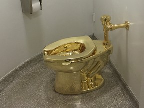 In this file photo taken on Septe. 15, 2016, a fully functioning solid gold toilet, made by Italian artist Maurizio Cattelan, is seen before going into public use at the Guggenheim Museum in New York.