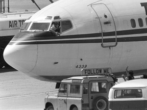 In this Wednesday, June 19, 1985 file photo, a hijacker points a weapon toward an ABC news media crew from the window of the cockpit of the Trans World Airlines jet at Beirut International Airport, Lebanon. (AP Photo/Herve Merliac, File)