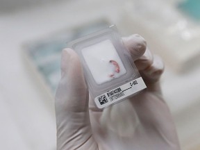 A research associate takes out a clinical sample (cancer cell) from -150 degree C Ultra-low Temperature Freezer at the Bioresource Research Center of Tokyo Medical and Dental University in Tokyo, Japan July 21, 2016.