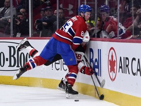 Canadiens defenceman Cale Fleury checks New Jersey Devils forward Blake Speers into the boards during the second period at the Bell Centre on Sept. 16, 2019.