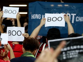 Soccer fans hold signs in support of anti-government protesters at a World Cup qualifier between Hong Kong and Iran, at Hong Kong Stadium, China September 10, 2019. (REUTERS/Athit Perawongmeth)