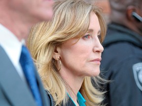 Felicity Huffman exits the courthouse after facing charges for allegedly conspiring to commit mail fraud and other charges in the college admissions scandal at the John Joseph Moakley United States Courthouse in Boston on April 3, 2019.