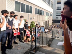 Secondary school students shout slogans as they form a human chain demonstrating against what they say is police brutality against protesters, after clashes at Wan Chai district in Hong Kong, China Sept. 9, 2019.