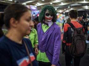 A cosplayer dressed as The Joker walks through the crowd at the second edition of the multi-genre entertainment comic and fan convention 'Comic Con Africa' in Johannesburg, South Africa, on Sept. 21, 2019.