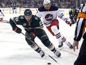 Minnesota Wild forward Kevin Fiala (22) is chased by Winnipeg Jets defenceman Ben Chiarot in Winnipeg on Tues., Feb. 26, 2019. (Kevin King/Winnipeg Sun)