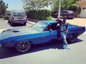 Kevin Hart poses with his car, a Plymouth Barracuda. (Instagram)