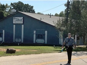 A Lancaster County Sheriff's deputy walks around the Old Skool Sports Bar and Grill, the scene of a shooting early in the morning, north of Lancaster, S.C. on Saturday, Sept. 21, 2019. (Jessica Holdman/The Post And Courier via AP)