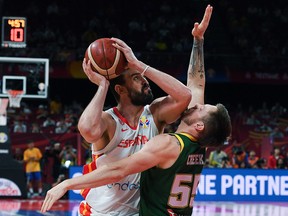 Spain's Marc Gasol fights for the ball with Australia's Patty Mills during the World Cup semifinal in Beijing on September 13, 2019. (GREG BAKER/AFP/Getty Images)