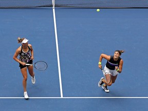 Elise Mertens (L) of Belgium and Aryna Sabalenka of Belarus return a shot during their Women's Double's final match against Victoria Azarenka of Belarus and Ashleigh Barty of Australia on Day 14 of the 2019 U.S. Open at the USTA Billie Jean King National Tennis Center on Sept. 8, 2019, in New York City.