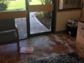 Broken glass covers the floor of an entranceway after a moose smashed its way into the Peace River North School District office in Fort St. John, B.C., in a Thursday, Sept. 12, 2019, handout photo.