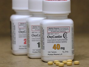 Bottles of prescription painkiller OxyContin pills, made by Purdue Pharma LP, sit on a counter at a pharmacy in Provo, Utah April 25, 2017. (REUTERS/George Frey/File Photo)