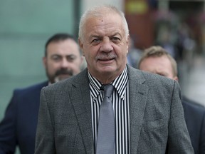 Rights campaigner Raymond McCord is seen outside Belfast High Court following an application for an injunction to prevent British Prime Minister Boris Johnson from suspending parliament, in Belfast, Northern Ireland, Friday Aug. 30, 2019. (Brian Lawless/PA via AP)