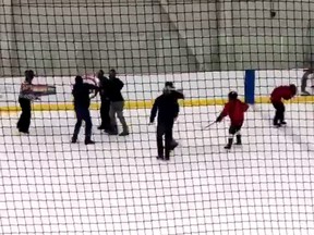 A referee is attacked during a kids' hockey tournament in Lethbridge, Alta. (Video screen grab)